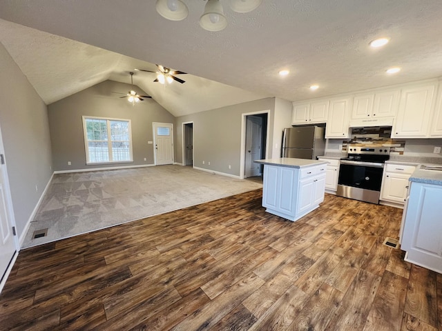 kitchen with white cabinetry, lofted ceiling, appliances with stainless steel finishes, and a center island