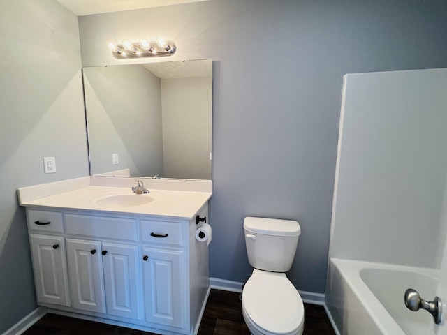 bathroom with hardwood / wood-style flooring, vanity, and toilet