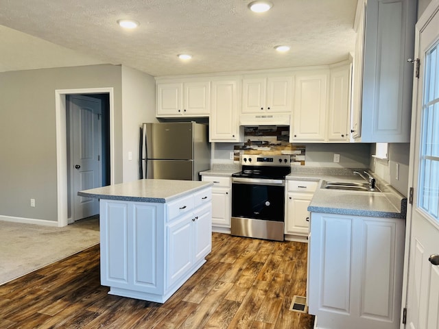 kitchen featuring white cabinetry, sink, a center island, and appliances with stainless steel finishes