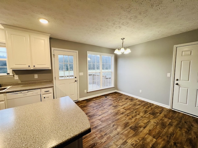 kitchen featuring white cabinetry, white dishwasher, dark hardwood / wood-style flooring, and pendant lighting