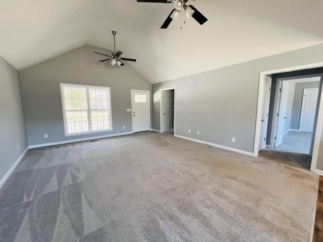 unfurnished living room featuring ceiling fan, lofted ceiling, and carpet flooring