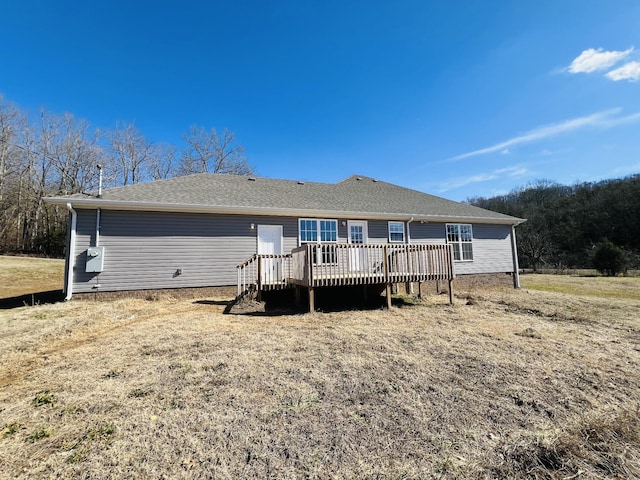 back of house with a wooden deck