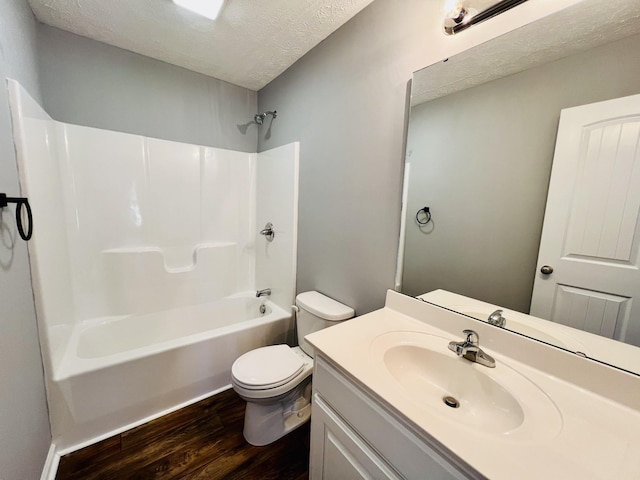 full bathroom with toilet, tub / shower combination, a textured ceiling, vanity, and hardwood / wood-style floors