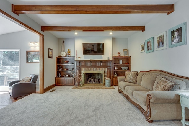 living room featuring a brick fireplace, beamed ceiling, and carpet flooring