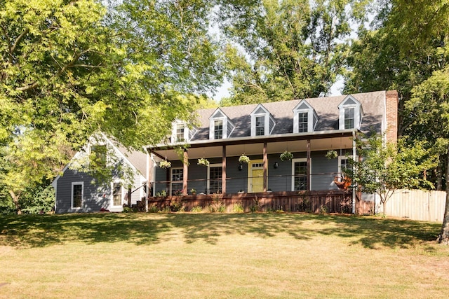 new england style home with a porch and a front lawn