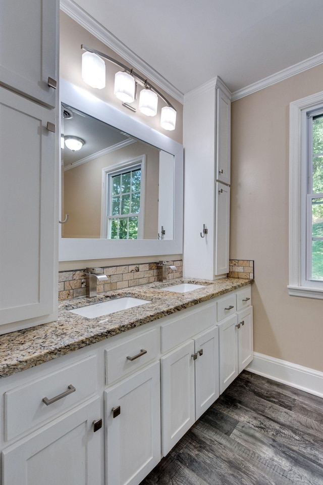 bathroom featuring vanity, backsplash, hardwood / wood-style flooring, and ornamental molding