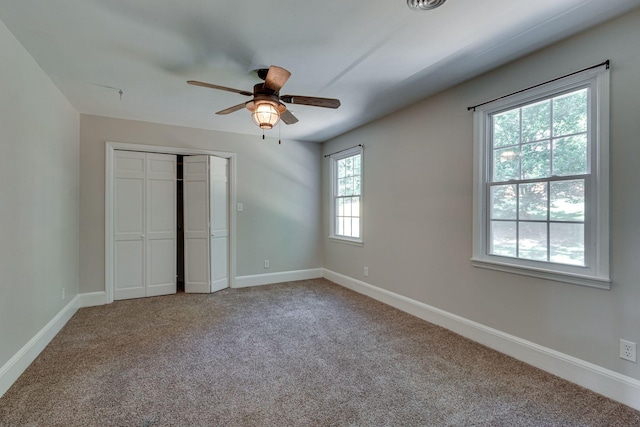 unfurnished bedroom with a closet, ceiling fan, and carpet