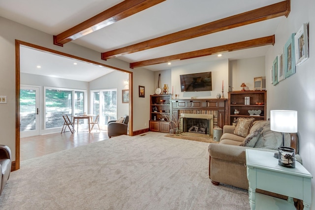 carpeted living room with a brick fireplace and vaulted ceiling with beams