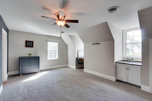 bonus room featuring vaulted ceiling, light carpet, and ceiling fan