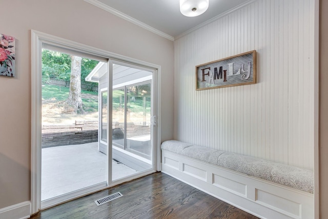 doorway with dark hardwood / wood-style flooring and ornamental molding