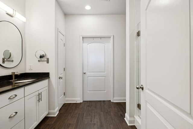 bathroom featuring hardwood / wood-style flooring and vanity