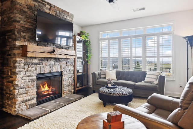 living room with dark wood-type flooring and a fireplace