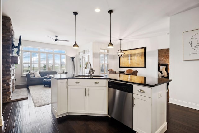 kitchen with white cabinetry, dishwasher, an island with sink, and hanging light fixtures