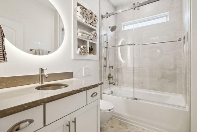 full bathroom with vanity, combined bath / shower with glass door, and toilet