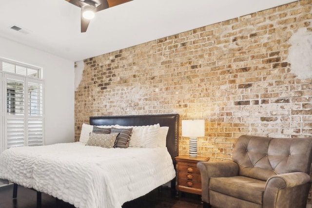 bedroom with brick wall and ceiling fan