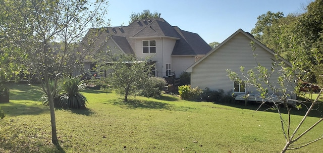 view of side of home with a yard