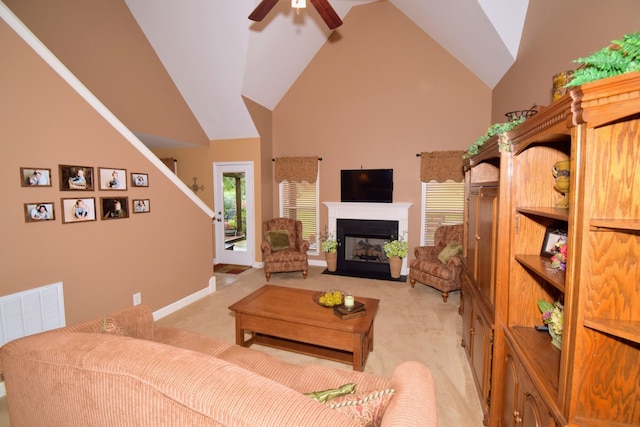 carpeted living room featuring high vaulted ceiling and ceiling fan