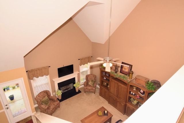 living room with carpet floors, high vaulted ceiling, and ceiling fan