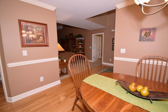 dining area featuring crown molding and light wood-type flooring