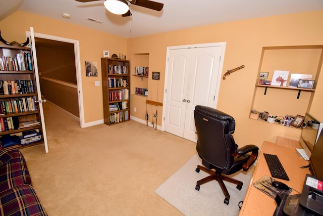 carpeted home office featuring ceiling fan