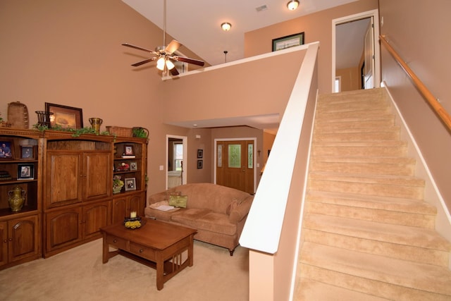 carpeted living room featuring high vaulted ceiling and ceiling fan