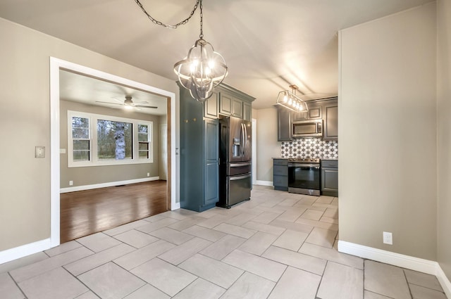 kitchen featuring decorative light fixtures, appliances with stainless steel finishes, gray cabinets, ceiling fan, and backsplash