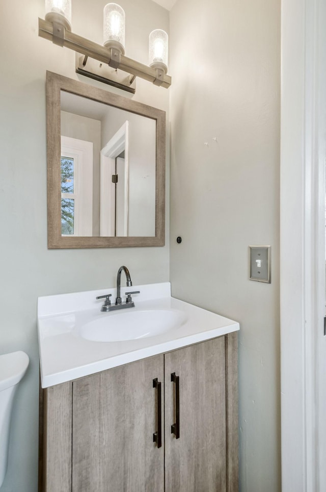 bathroom featuring vanity and toilet