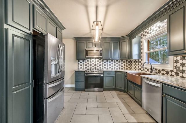 kitchen featuring gray cabinetry, sink, decorative backsplash, and stainless steel appliances