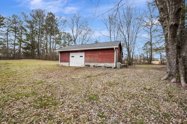 view of outdoor structure with a yard and a garage