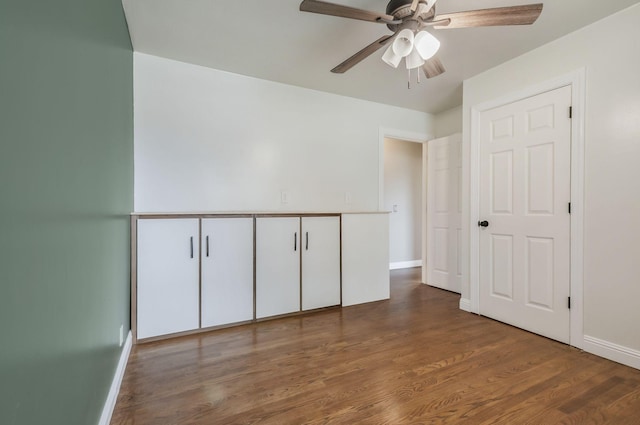 unfurnished bedroom featuring dark hardwood / wood-style flooring and ceiling fan