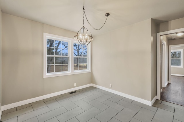 unfurnished dining area with a notable chandelier and light tile patterned floors