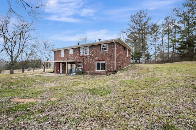 rear view of property with a lawn