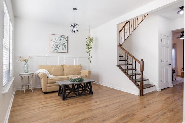 living room featuring ceiling fan and light wood-type flooring