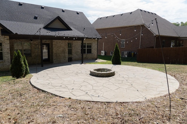 back of property featuring a patio area and a fire pit