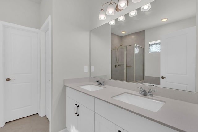 bathroom featuring tile patterned floors, vanity, and a shower with door