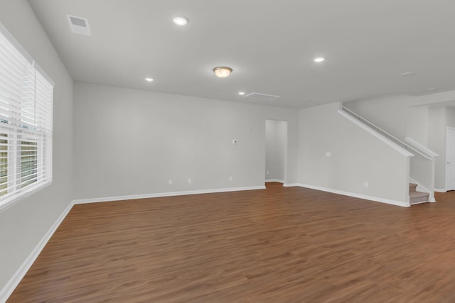 unfurnished living room featuring dark hardwood / wood-style flooring