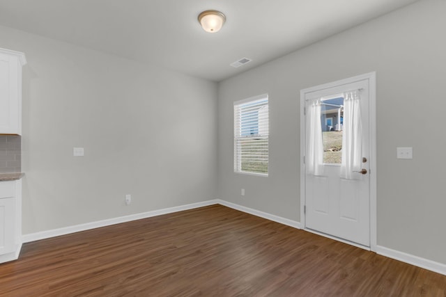 foyer entrance with dark hardwood / wood-style floors