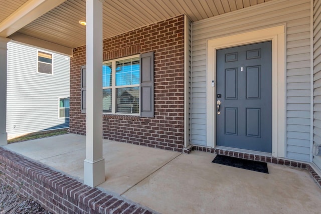 doorway to property featuring covered porch