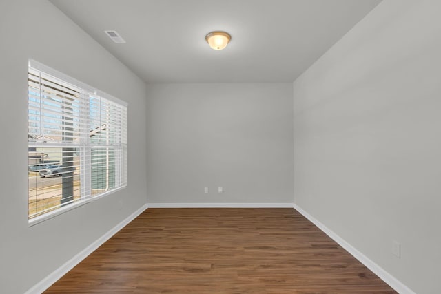 spare room featuring dark wood-type flooring