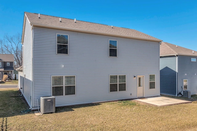 rear view of house with cooling unit, a yard, and a patio