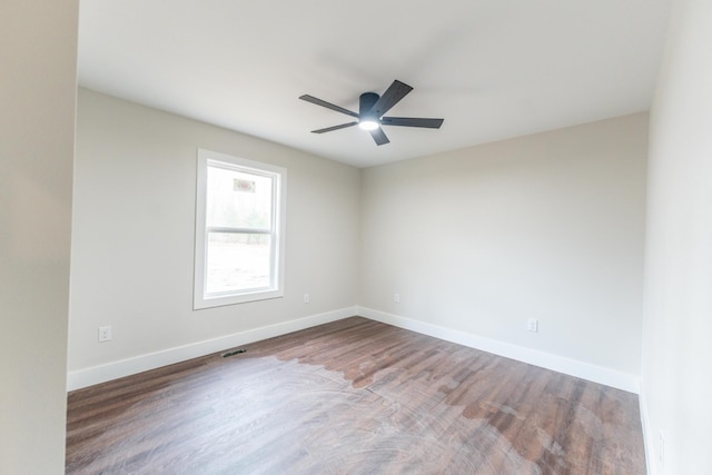 spare room with ceiling fan and wood-type flooring