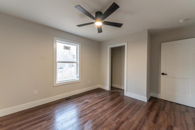 unfurnished bedroom with dark wood-type flooring and ceiling fan