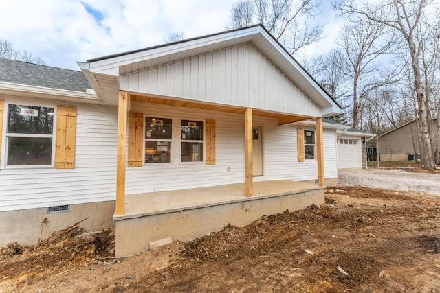 view of front facade featuring a porch and a garage