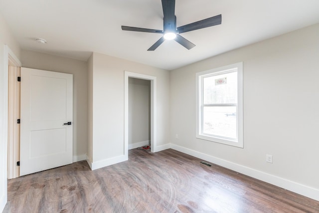 unfurnished bedroom featuring a closet, ceiling fan, and light wood-type flooring