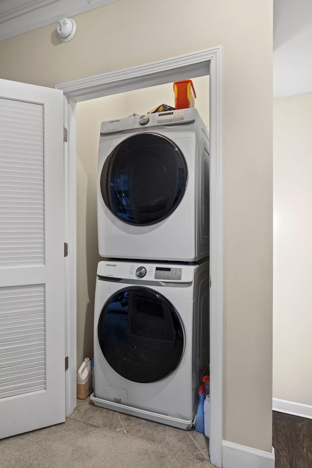 washroom featuring stacked washer / dryer