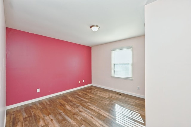 spare room featuring hardwood / wood-style floors