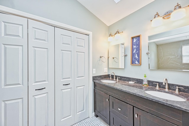 bathroom featuring lofted ceiling and vanity