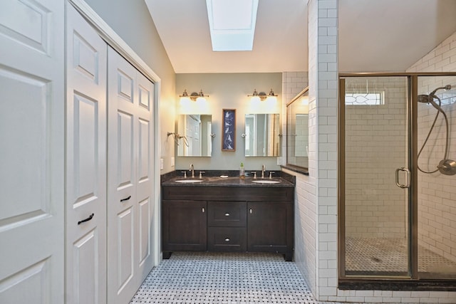 bathroom featuring vanity, lofted ceiling with skylight, and an enclosed shower