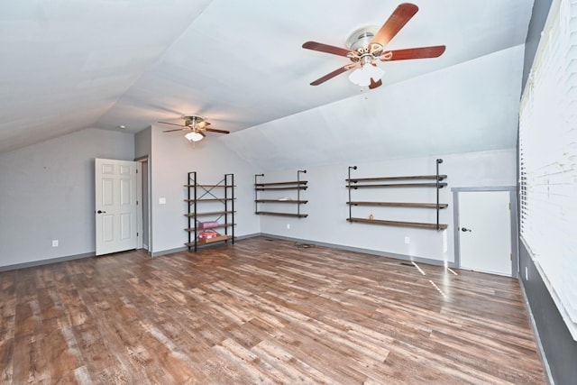 additional living space with vaulted ceiling and dark hardwood / wood-style flooring