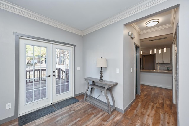 entryway featuring dark wood-type flooring, ornamental molding, and french doors